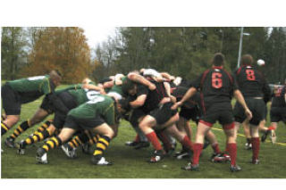 (Top) Fort Lewis and Bangor mix it up in a scrum during Saturday’s Commander’s Cup at Strawberry Fields in Poulsbo. Bangor won 36-24.