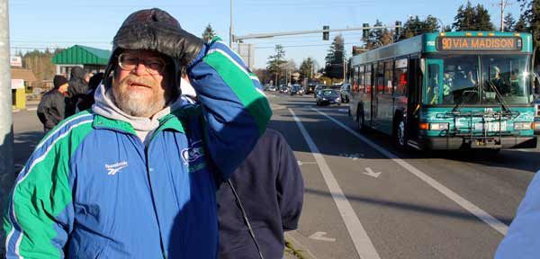 Rodney Swenson of Kelso waits for a bus at the Highway 305 bus stop near Hostmark Street