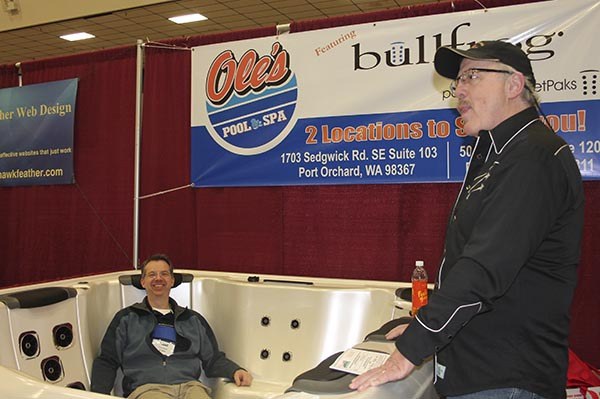 Owner Ole Schow relaxes in a spa at the West Sound Expo Thursday at the Kitsap County Fairgrounds.