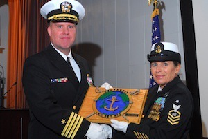 Port Orchard resident and U.S. Navy Captain Ed Pierson (left) receives a hand-carved plaque in appreciation for his service from ITCS Jacqueline Riner