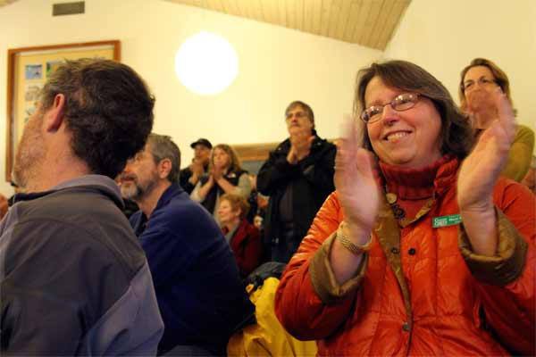 Village Green Foundation President Mary McClure reacts enthusiastically after a $1 million donation for the Kingston Community Center at Village Green was announced Jan. 26 inside the current community center.