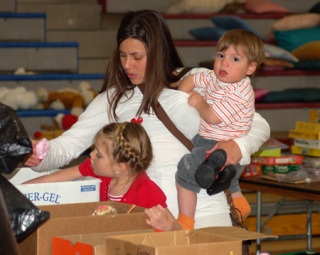 Michelle Nusz and her two children Katie and Samuel spend the day sorting through toys at the RAGS sale April 18 at the Kitsap County Fairgrounds Pavilion.