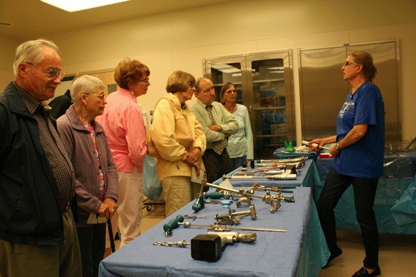 Visitors examine tools used in hip and knee replacements.