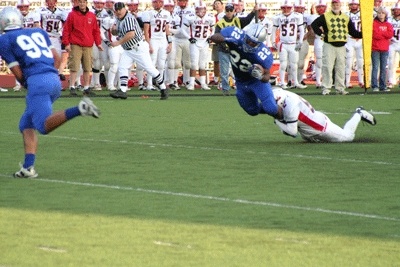 Olympic running back Larry Dixon (22) dives for extra yardage during the second quarter of the Trojans' 34-13 victory at Silverdale Stadium Friday.