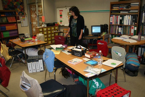 Fourth and fifth grade students in Jennifer Roger’s class at Cougar Valley Elementary school practice their earthquake emergency response during a drill Wednesday. The Central Kitsap District school routinely drills for emergencies.