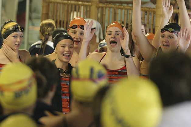 Members of the Cougars swim team yell back and forth with Bainbridge Island swimmers during the inner tube races at the end of the swim meet last weekend.