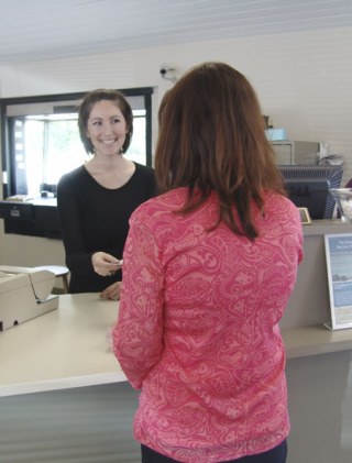 Clerk Nicole Betcher helps a customer at the new Port Orchard Bank branch (formerly Westsound Bank) on Tuesday.