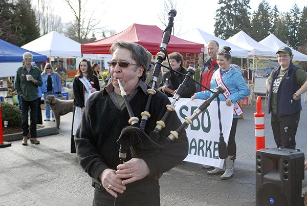 The Poulsbo Farmers Market's 2013 season opened with celebration — and bagpipe music. A proposal to move the farmers market to Nelson Park fell through