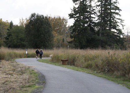 Walkers stroll on Clear Creek Trail Monday. The Clear Creek Task Force is working with Kitsap County to extend the trail north to Kegley Road.