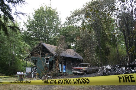 A candle was blamed for a blaze that destroyed two houses near Manette Tuesday.