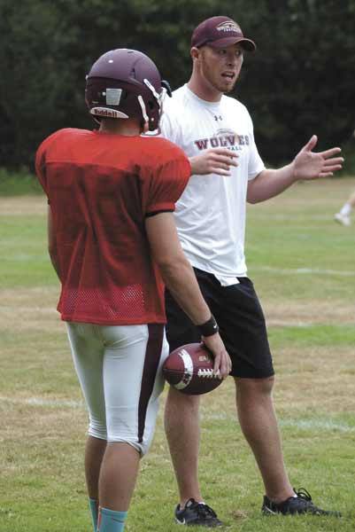 South Kitsap Wolves quarterbacks coach Jared Prince works with the 2013 players in the preseason recently. Prince returns to Kitsap after four years with the Texas Rangers organization.