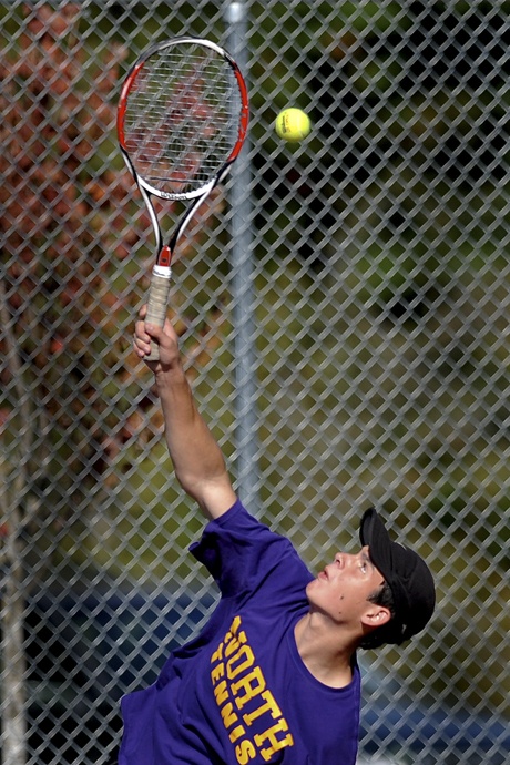 North Kitsap sophomore Zach Fohn serves to his friend