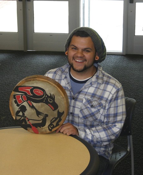 Cody Narte displays a drum he painted for North Kitsap High Principal Kathy Prasch.