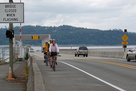 Bikers travel the new Hood Canal Bridge shoulder. The shoulders will be partially closed in the upcoming weeks as crews place safety barriers.