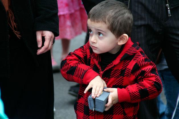 Young Abdulah Saleh opens up a small box containing the keys to his family’s new Habitat for Humanity home at Bay Vista in Bremerton.