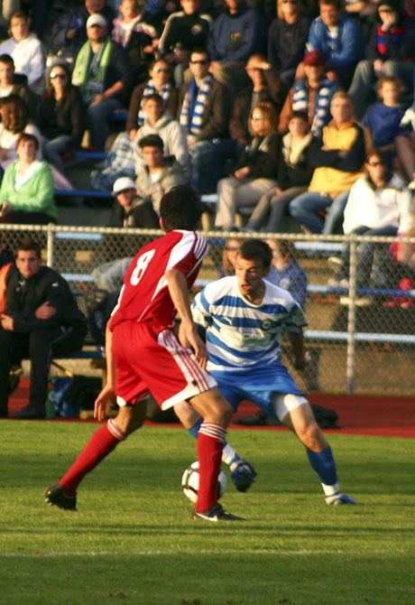 Pumas midfielder David Gray attempts to dribble past Manuel Vasquez of the Bay Area Ambassadors Tuesday at Bremerton Memorial Stadium.