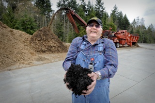 Ron Phillips of Emu Topsoil holds a batch of finished compost at the Kingston facility. The company recently won an award for the excellence in recycling.