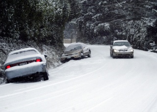 Cars had a difficult time going up and down Tracyton Boulevard NW Thursday road due to ice and snow conditions. Tracyton Road was littered with cars in the ditches. More snow is expected for Kitsap County on Sunday.