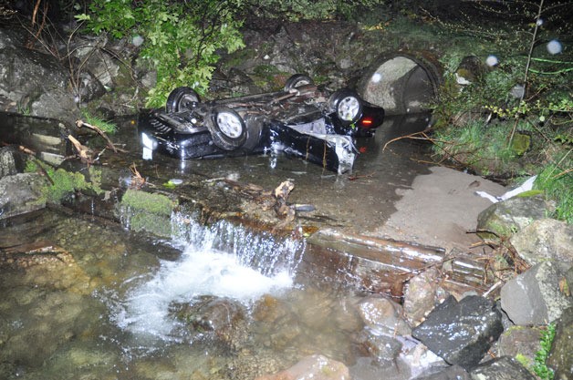 The 1995 Ford Mustang came to rest in the creek alongside Seabeck Highway and Larsen Lane.