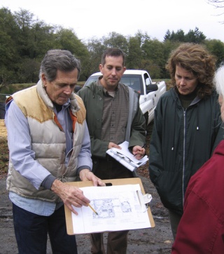 Architect Miles Yanick and Kitsap County Parks and Recreation staff Matt Keough and Martha Droge look over the Village Green plan at a site walk-through to determine the condition the park will be left in during the interim until a new community center and senior housing can be built.