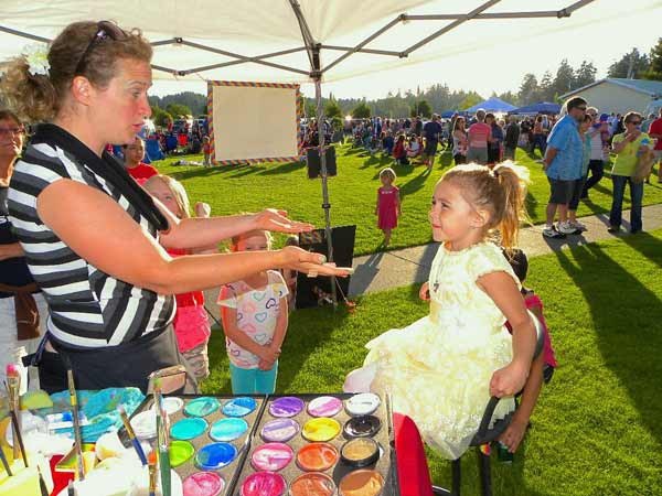 A girl prepares to have her face painted during the Food For Kids fundraiser at Mike Wallace Park June 7.