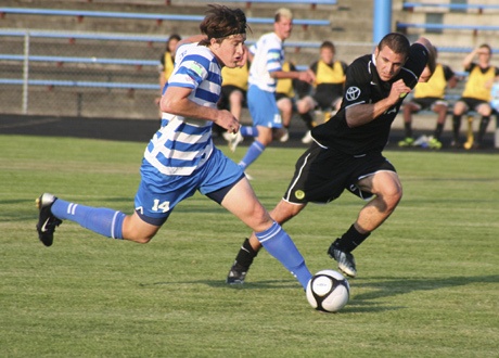 Kitsap Pumas forward Stephen Phillips races past a Portland Timbers defender June 9. The Pumas picked up their only loss of the season in the game. Kitsap clinched their division July 11 in a win over the Abbotsford Mariners.