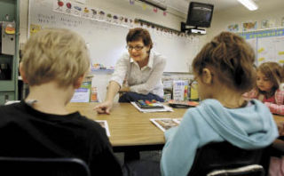 Pearson Elementary teacher Karen Trudeau works with a small group of students during her morning reading time Monday.