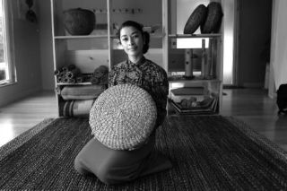 Lishu Rodriguez displays a Friendly Product grass pillow in her Poulsbo showroom. Rodriguez and husband Leo help and give back to native artists by selling the artists’  pieces at the Friendly Product showroom in Poulsbo.