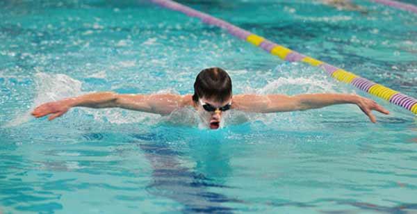 North Kitsap swimmer Benjamin Machen races down his lane at the North Kitsap Community Pool on Tuesday. Machen is one of seven individual swimmers on the NK team to achieve a district qualifying time.