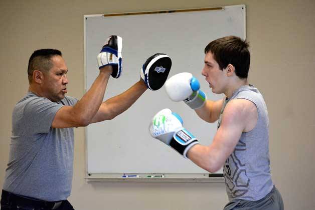 Mario Cabillo spars with a 14-year-old student from Central Kitsap High School