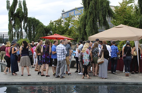 Attendees wait in line for a wine sampling at the seventh Kitsap Wine Festival in Bremerton on Aug. 8.