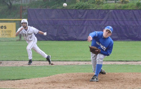 Olympic High School senior Riley Crow hurls a pitch against the Vikings of North Kitsap High School. Olympic is in second place in the Olympic league behind North Kitsap.