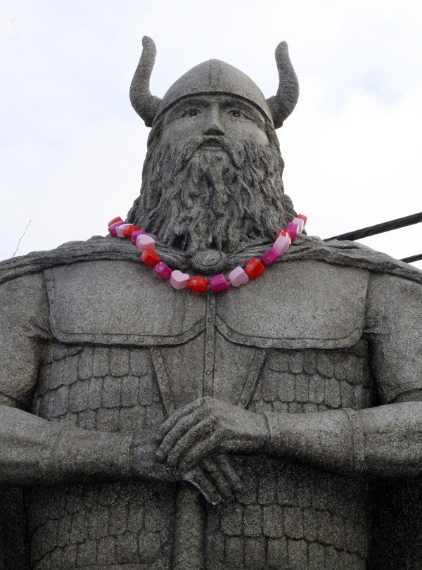 The Norseman statue at Viking Avenue and Lindvig Way in Poulsbo sports a Valentine's Day necklace of pink and red hearts