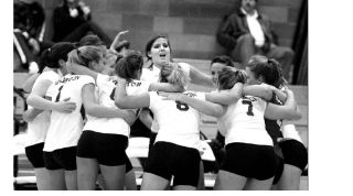 The Kingston High School Volleyball team huddles before a home game. The North Kitsap School District offers 10 athletic opportunities for boys and girls at the high school level throughout the year.