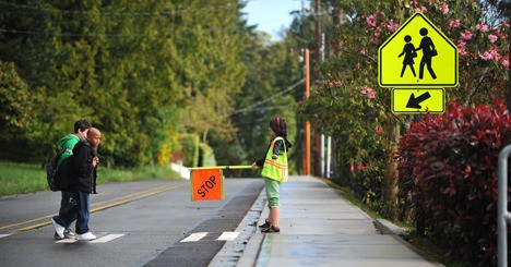 Suquamish Elementary fifth-grader Danie Cummings helps students cross the street safely as a member of the school’s safety patrol.