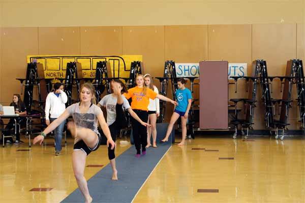 North Kitsap gymnastic students warm up Nov. 25 in the North Kitsap High School Commons.  The gymnastics programs for both NKSD high schools lost their practice facility when Zero Gravity closed earlier this month.