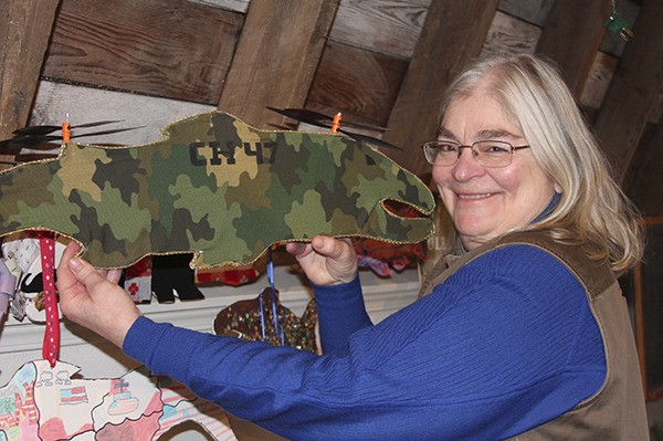 Mary Earl comes face-to-face with a decorated salmon from a previous auction