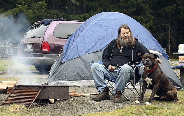 Otto McElbain and his dog Big Boy enjoy the fire in Millersylvania State Park near Olympia. McElbain has been homeless since August 2013 and finds the Discover Pass fee to be “very reasonable.”