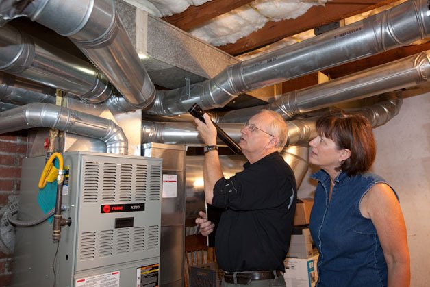 RePower Energy Advisor Daniel Josephsen explains the benefits of sealing ductwork to Bremerton homeowner Jaime Forsyth. Josephsen has assessed more than 800 homes for RePower.