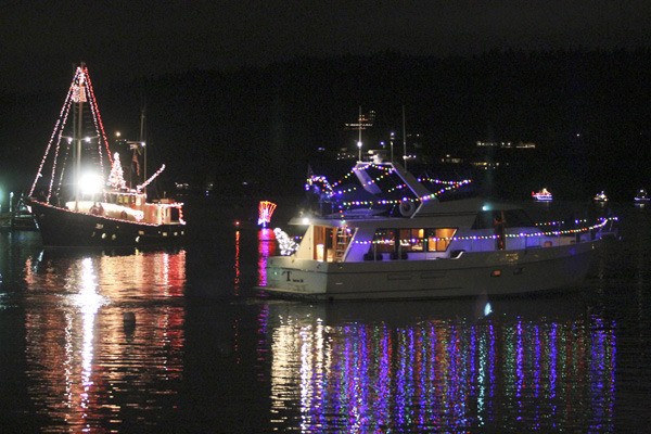 Poulsbo Yacht Club shows off their decorated boats in Liberty Bay last Friday night.