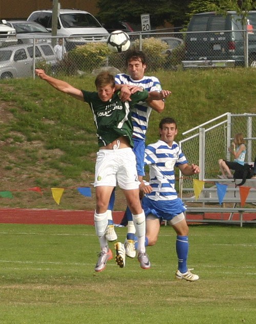 Kitsap Pumas defender Daniel Scott heads the ball over Portland Timbers U23 forward Brian Ramsey Sunday at Bremerton Memorial Stadium.