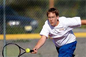 A Kingston High tennis player practices before the season began last year.