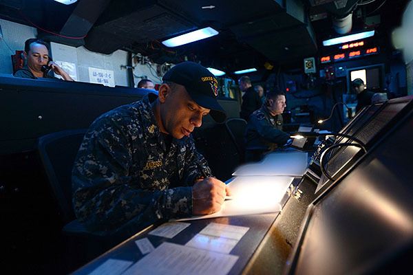 Senior Chief Operations Specialist Douglas Anderson takes notes in Tactical Force Command and Control (TFCC) during a Fleet Synthetic Training-Joint Exercise aboard USS John C. Stennis (CVN 74). Stennis is currently undergoing an operational training period in preparation for future deployments.