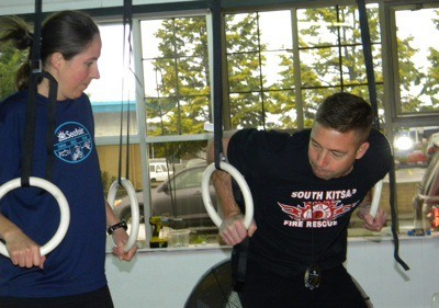 Crossfit member Erica Martinson gets on-the-ropes instruction from Mick Davis