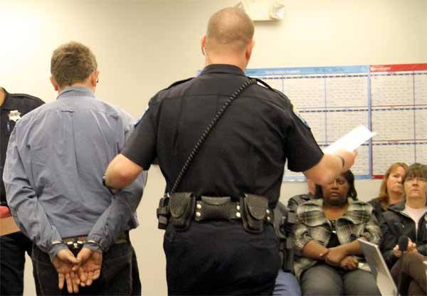 Cecil Thomas is escorted from a courtroom in Kitsap County District Court following his sentence for driving with a suspended license on Sept. 23