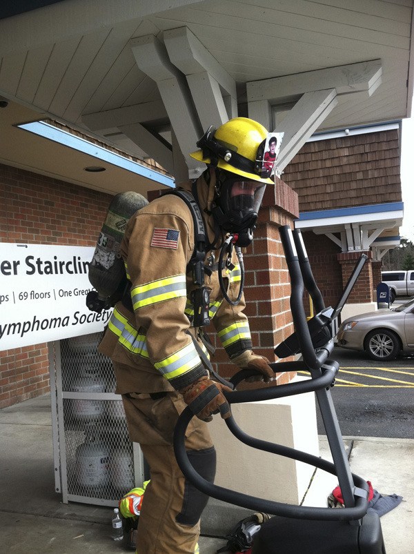 NKF&R firefighter Heath Clark uses a stairstepper to simulate the 69 stories of climbing that he’ll be doing in full firefighting gear this weekend.