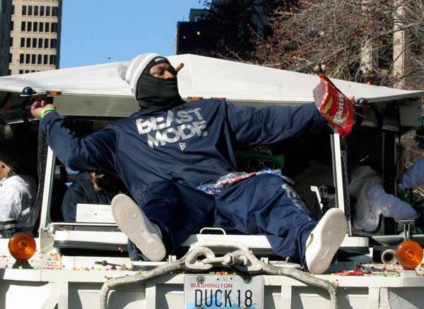 Seahawks running back Marshawn Lynch throws Skittles to fans Feb. 5 during the victory parade.