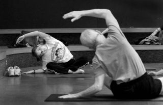 Poulsbo Middle School seventh-grader Clara Lund watches instructor Ed Woods during an after school yoga class at the school. Teachers and students have been participating in the new club.