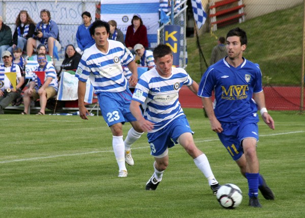 Mark Lee of the Kitsap Pumas defends against the Tacoma Tide's Daniel Gray