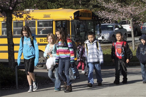 Breidablik Elementary School students head to class after being dropped off by the bus. Parents are considering starting a charter school in the wake of the school board’s decision to close Breidablik.